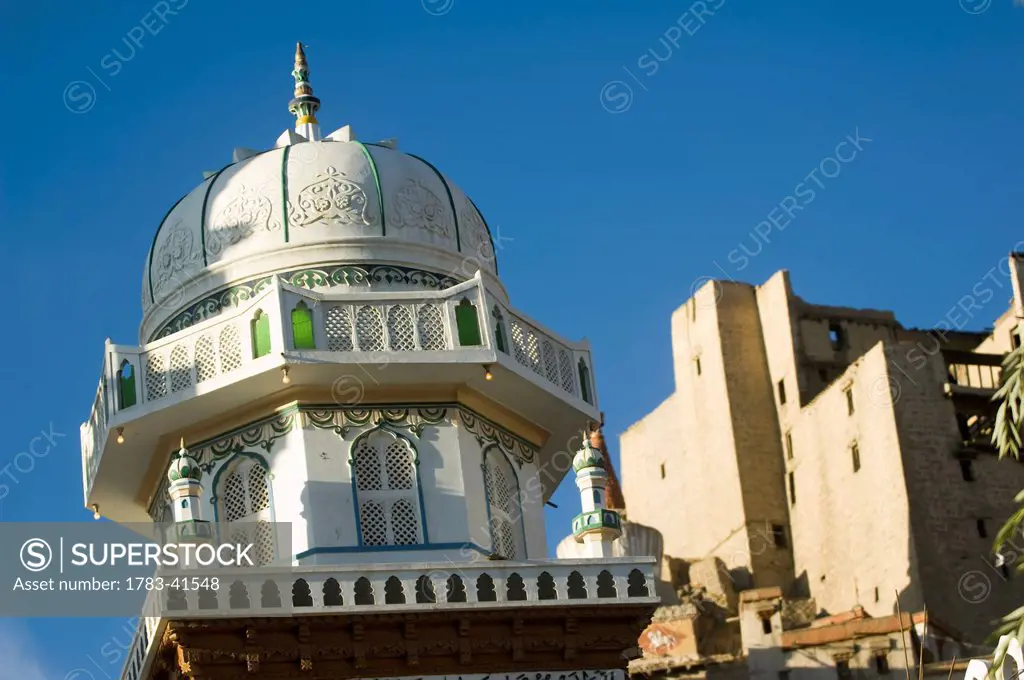 Jama Masjid mosque in Leh with Leh Palace behind. Leh was the capital of the Himalayan kingdom of Ladakh, now the Leh District in the state of Jammu a...