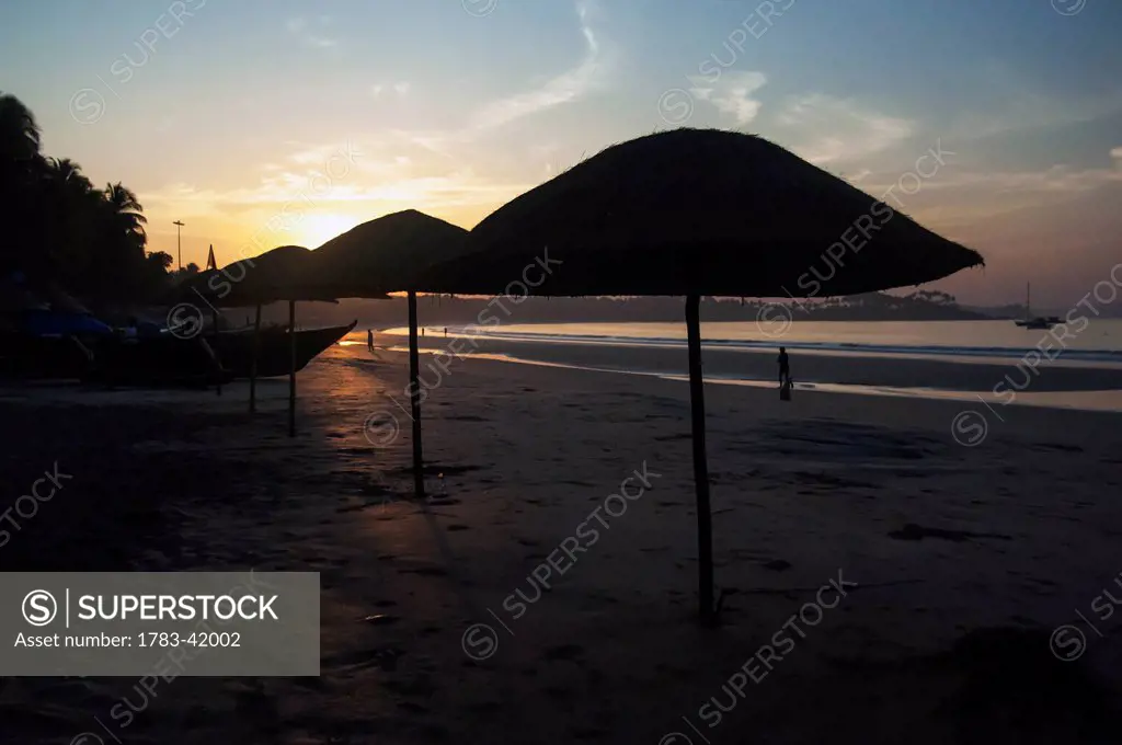 India, Sun shades at sunset on Palolem Beach; Goa