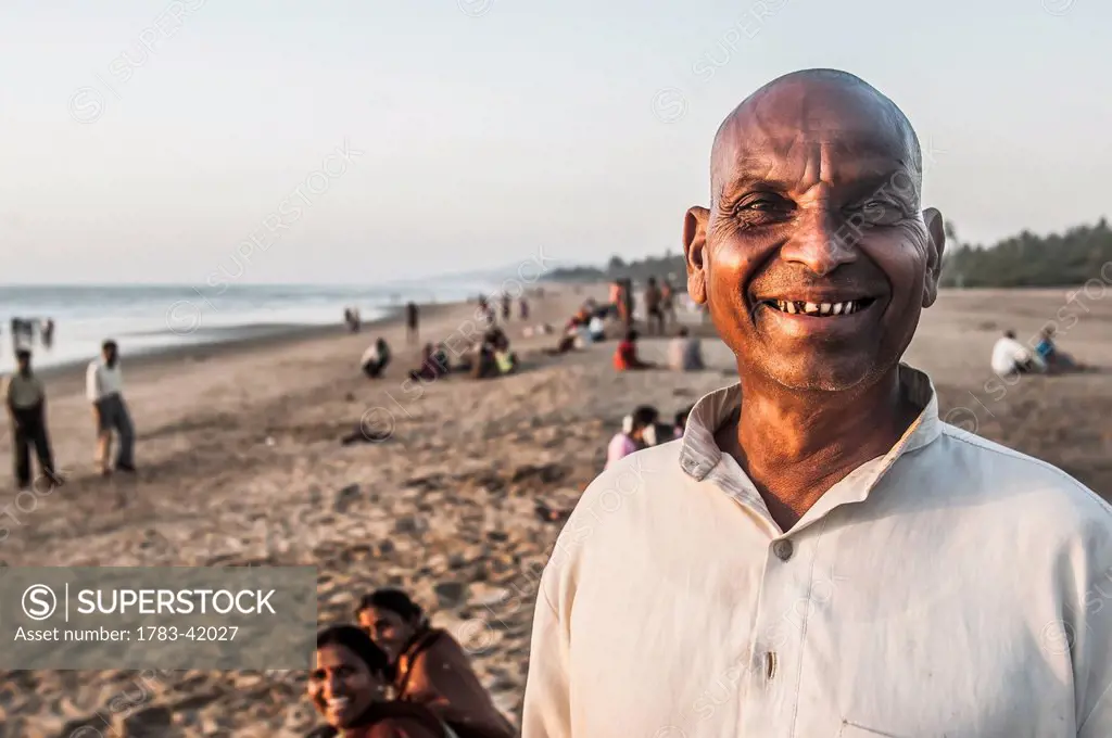 India, Karnataka, Portrait of Indian man and his family on Gokarna Beach; Gokarna