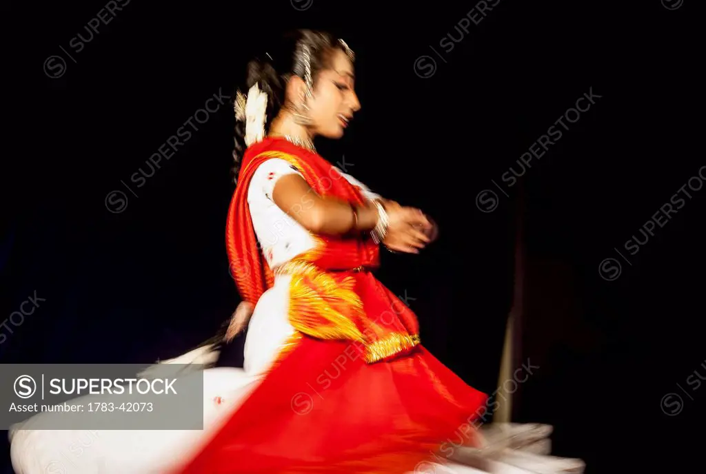 India, Karnataka, Young girl dancing in traditional dress; Udupi