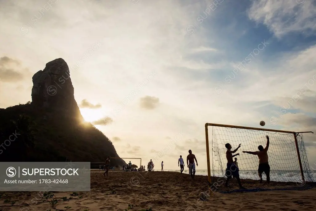 Playing football in Praia da Conceicao, Unesco World Heritage Site; Praia da Cachorro, Fernando de Noronha, Pernambuco, Brazil