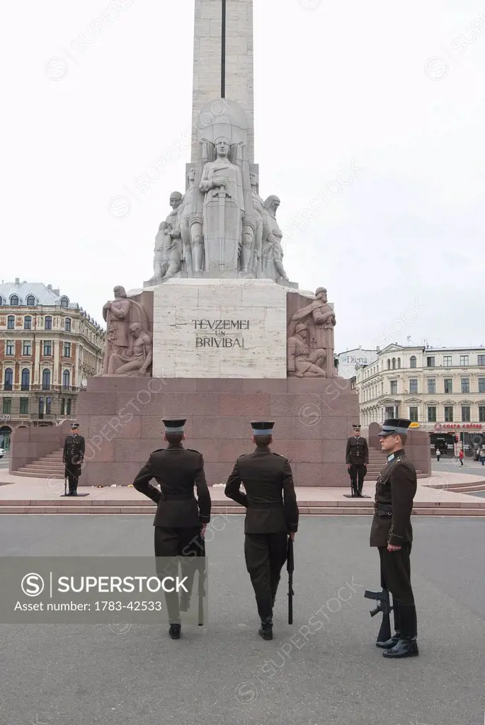 Soldiers on honor guard under monument; Riga, Latvia