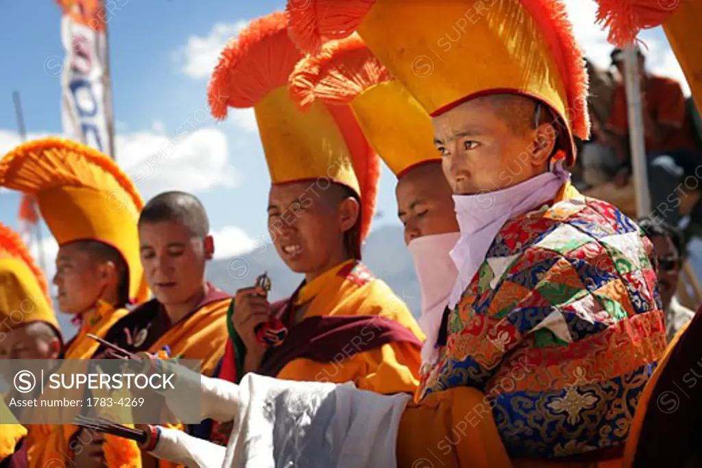 Nuns in traditional dress with yellow orange hats and robes at 800 year old birthday celebration / rituals of the Buddhist Drukpa Lineage, Naro Photang Shey, ( Shey Monastery ), Leh Ladakh, Indian Himalayas, India, Nuns in traditional dress with yellow orange hats and robes at 800 year old birthday 