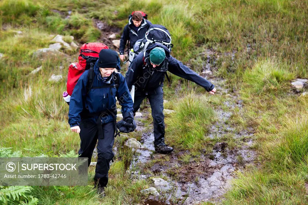 Hikers among hills of Western Lake District; Cumbria, England, UK