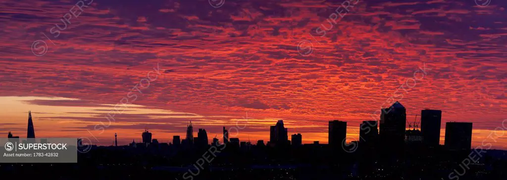 Panoramic sunset over City of London and Canary Wharf; London, England, UK