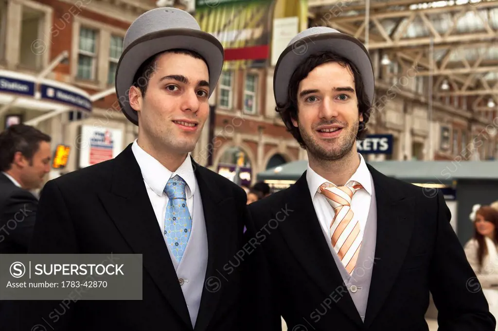 Elegant men at Waterloo Station for Lady's Day at Royal Ascot; London, England, UK