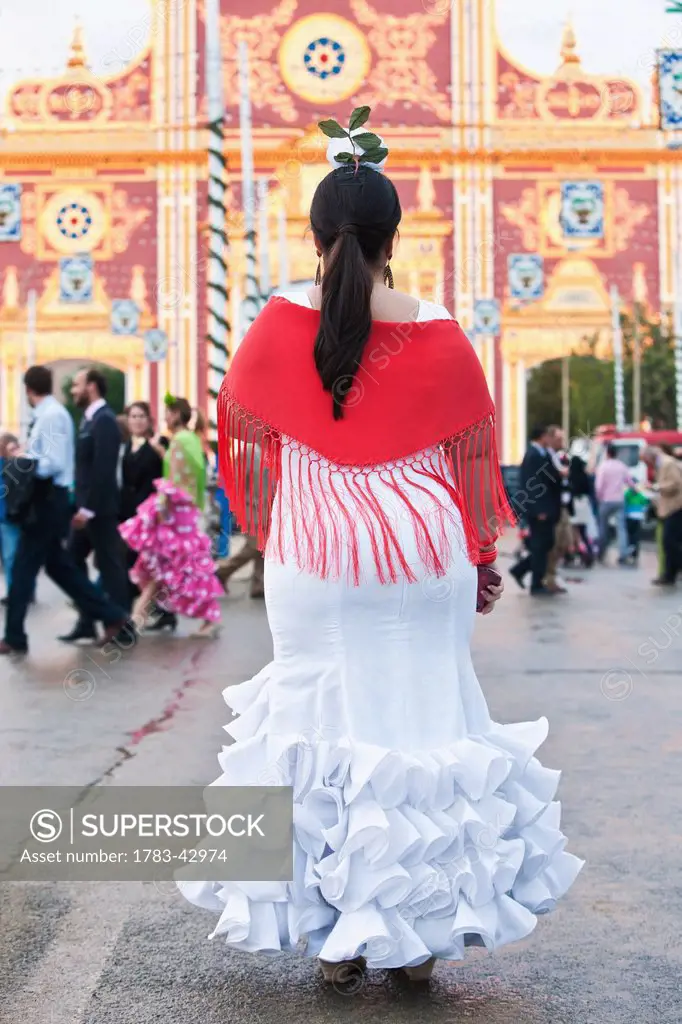 April Feria Festival, woman in traditional dress; Seville, Andalucia, Spain