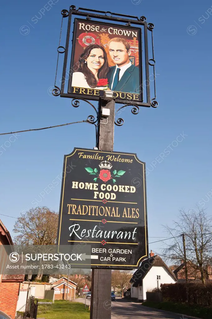 Prince William and Catherine, Duchess of Cambridge painted on pub sign at High Street; Tilshead, Wiltshire, England, UK