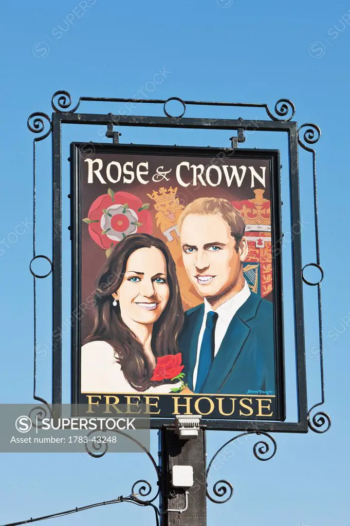Prince William and Catherine, Duchess of Cambridge painted on pub sign at High Street; Tilshead, Wiltshire, England, UK