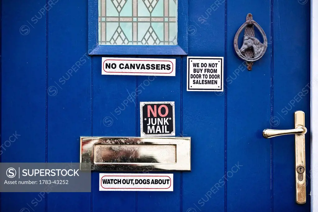 Close up of blue door with signs