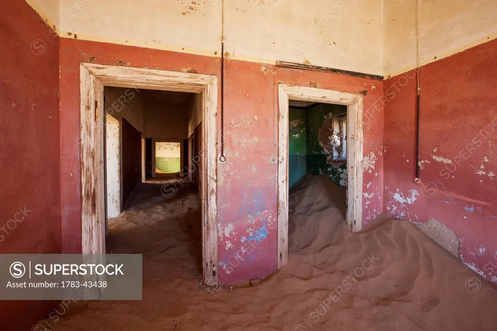 Sand in red room; Kolmanskop Ghost Town, Namibia