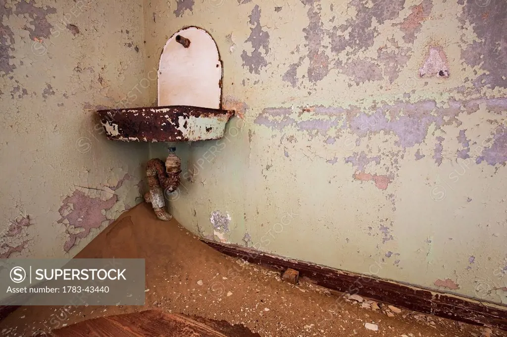 Sink and sand in abandoned house; Kolmanskop Ghost Town, Namibia