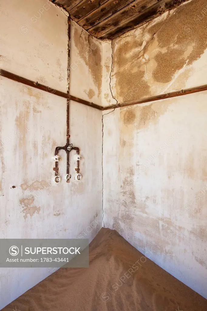 Outlet and sand in abandoned house; Kolmanskop Ghost Town, Namibia