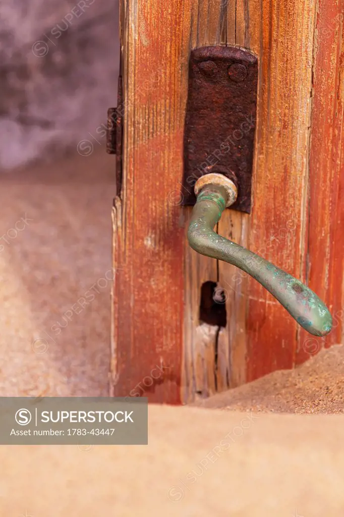 Doorknob and sand; Kolmanskop Ghost Town, Namibia