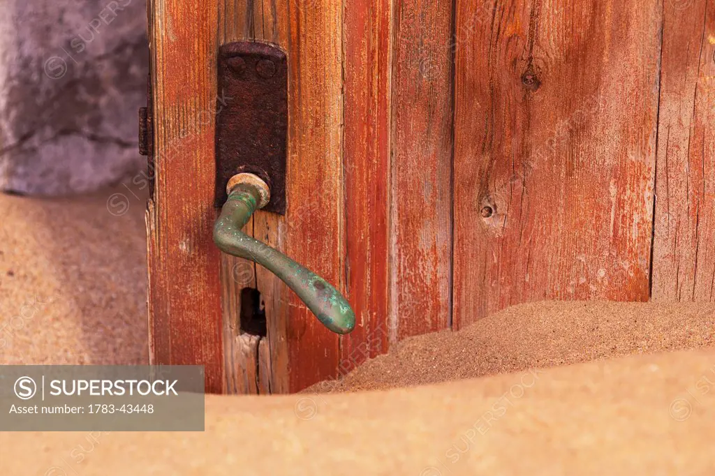 Doorknob and sand; Kolmanskop Ghost Town; Namibia