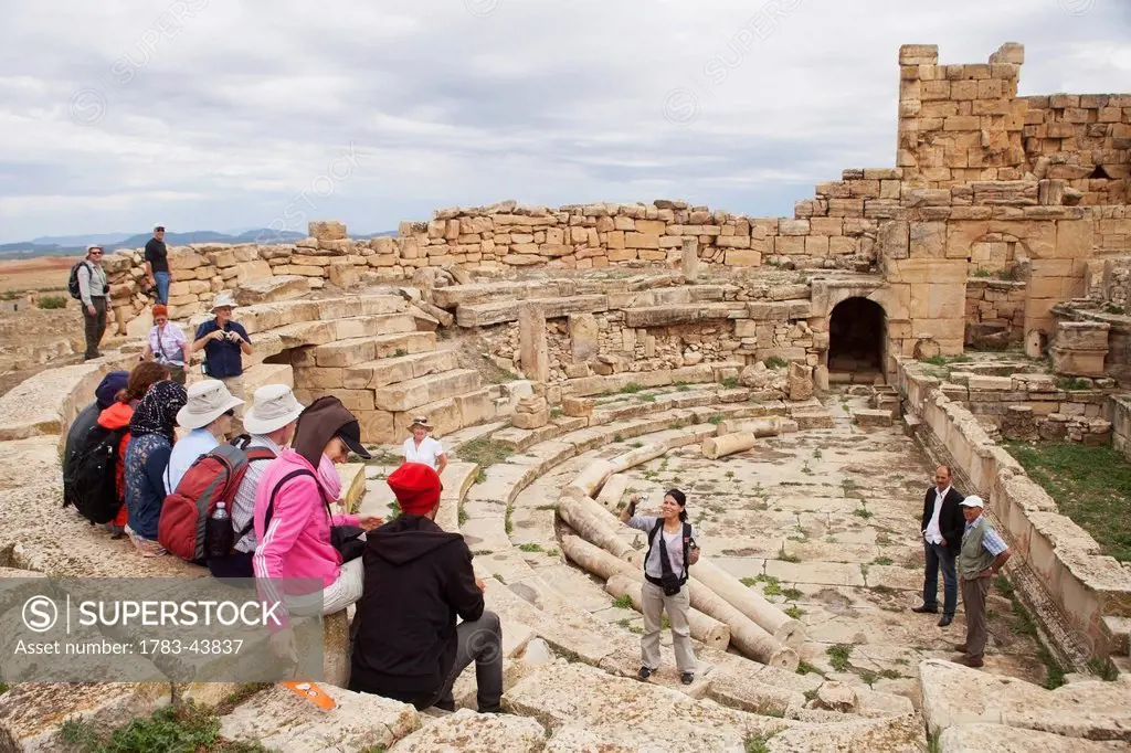 Local female archaeology students and visiting tour group, the Roman theatre, Madure site, near Souq Ahras; Algeria