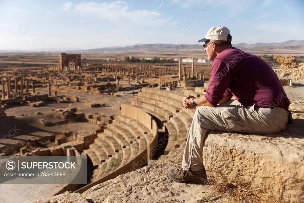 Tourist surveys the theatre and Roman ruins, Timgad, near Batna; Algeria