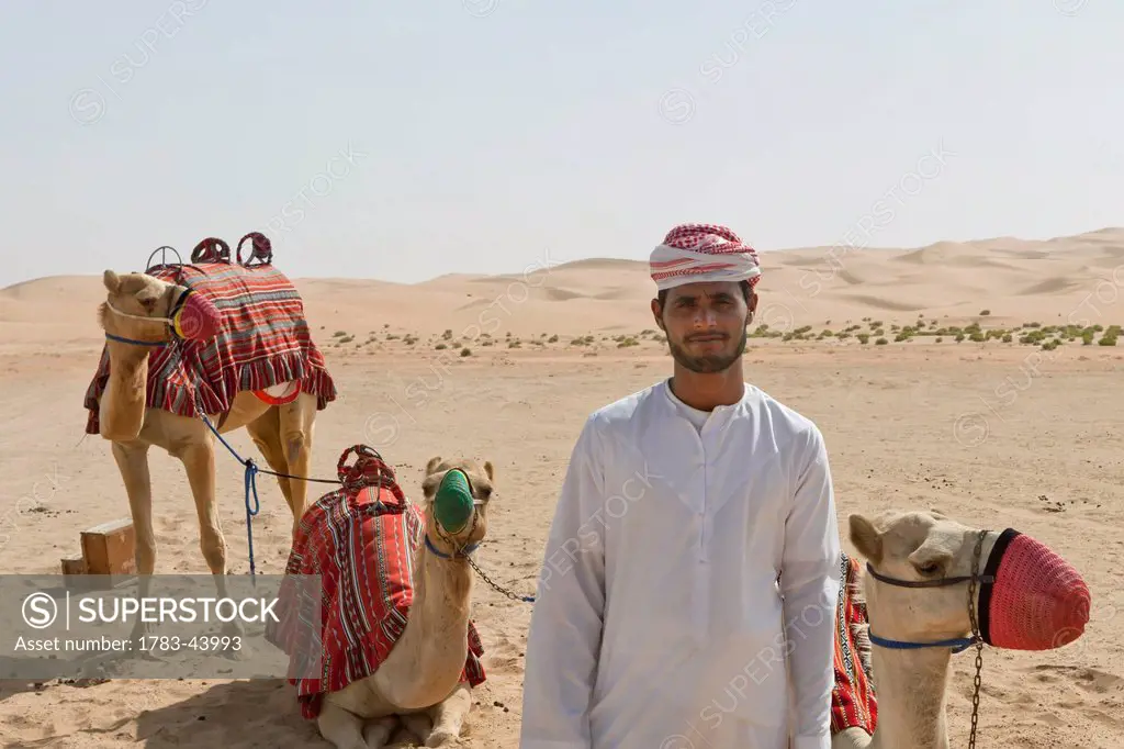 A local camel handler in Empty Quarter in Liwa Oasis; Liwa Oasis, Abu Dhabi, United Arab Emirates