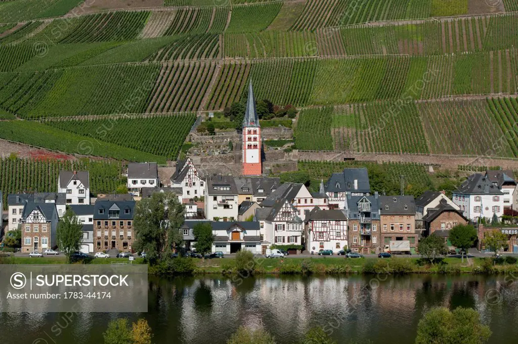 Fields and a village on the edge of a river in Mosel valley; Zell, Rhineland-Palatinate, Germany