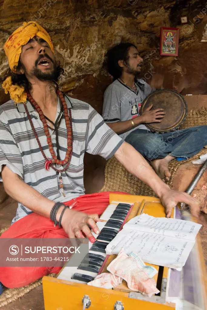 Locals singing mantras (kirtan) accompanied by harmonium; Pashupathinath, Nepal