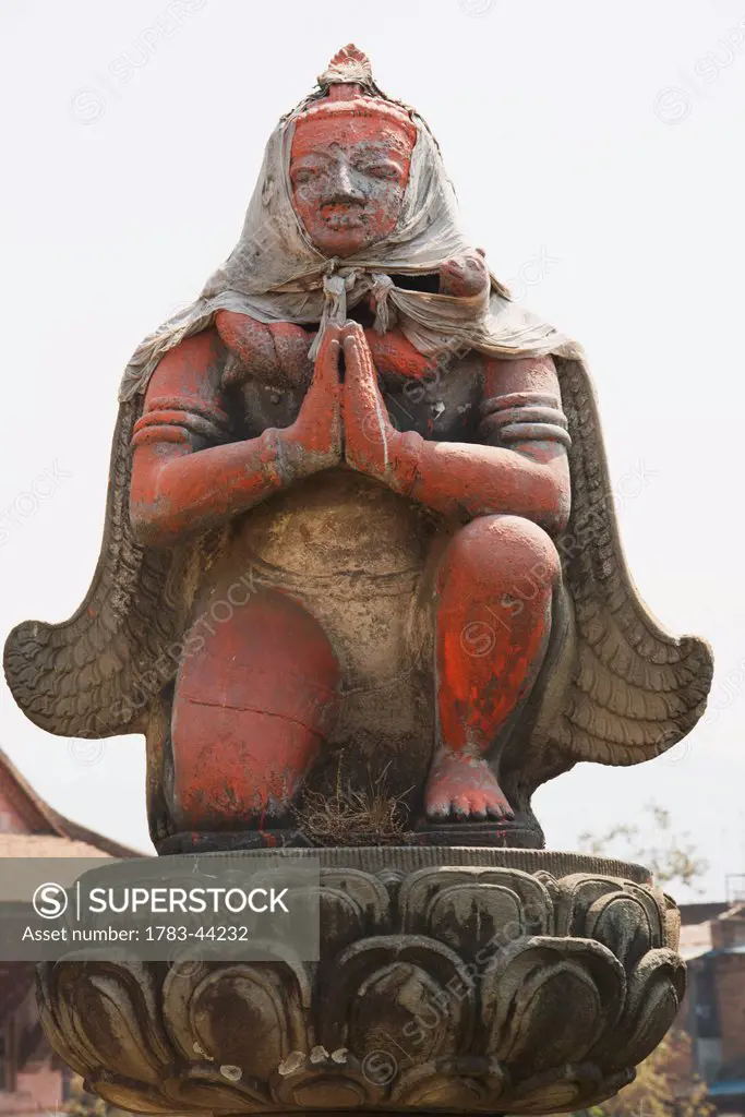 Wooden statue of Garuda on a pillar outside a temple; Bhaktapur, Nepal