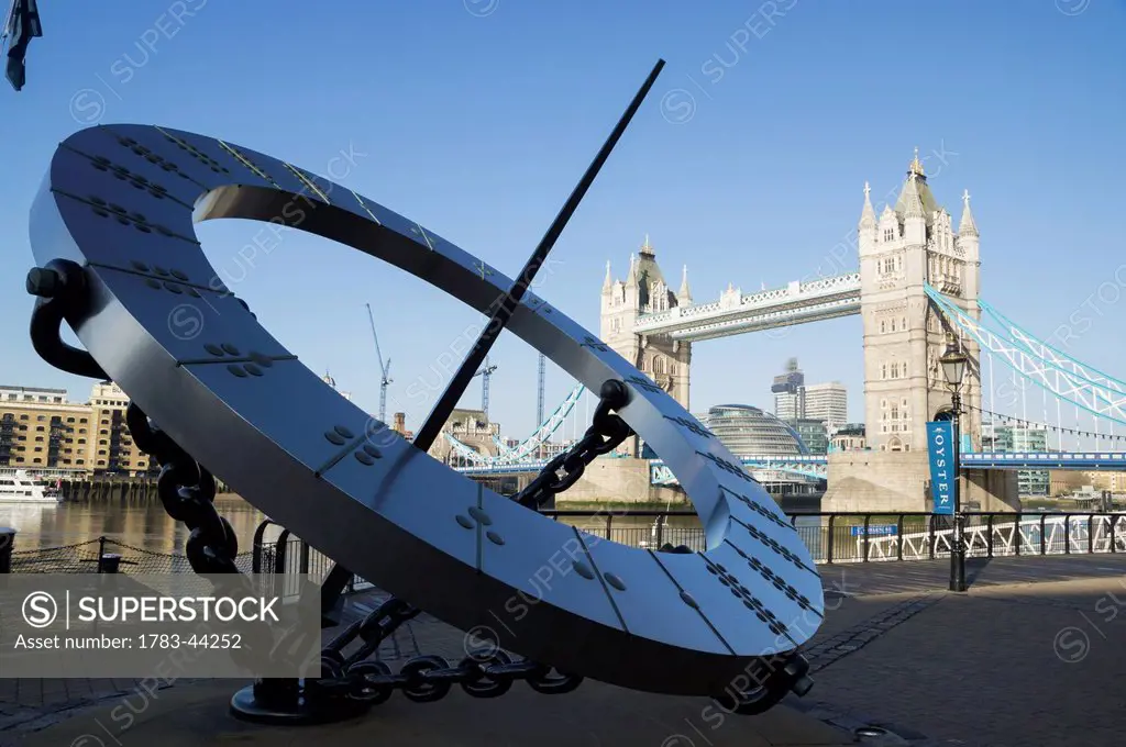 A large circular sculpture on the riverbank of the River Thames; London, England