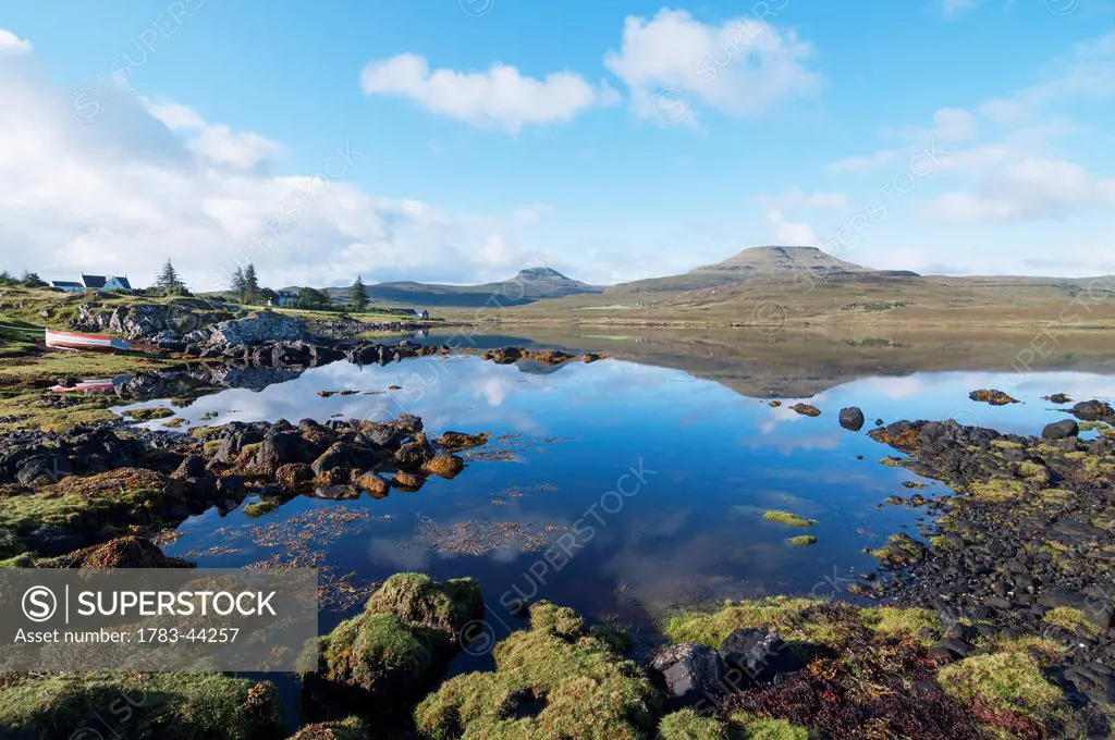 Landscape of shoreline and tranquil water of the Isle of Skye; Skye, Scotland