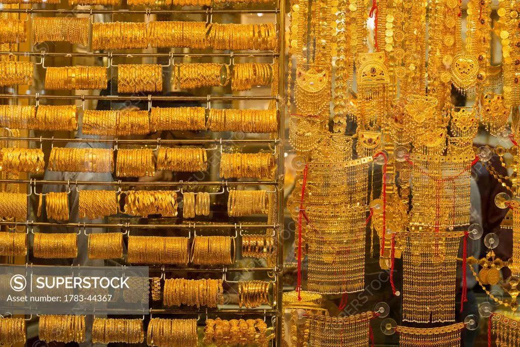Gold jewellery on display in window in the gold souk; Dubai, United Arab Emirates