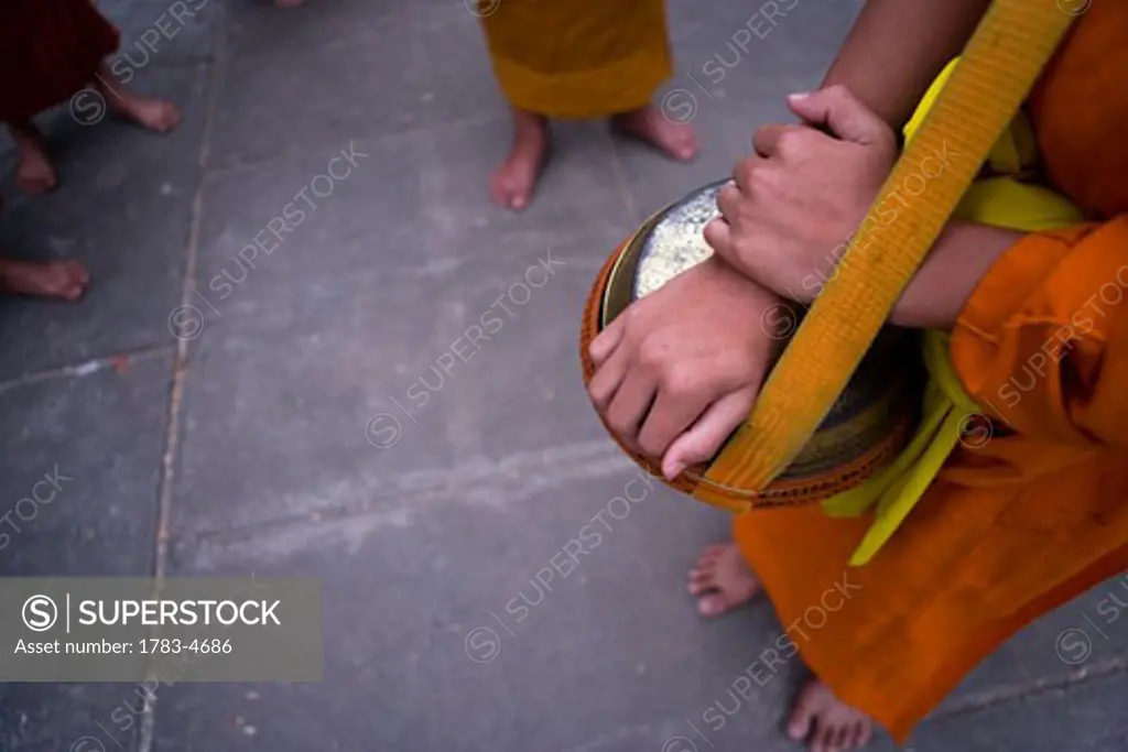 Novice monks out collecting alms at dawn in Luang Prabang,low section, Laos