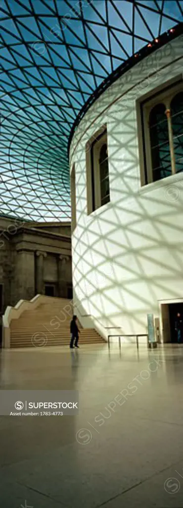 Silhouette of man passing Reading Room in Great Court of British Museum, London, England