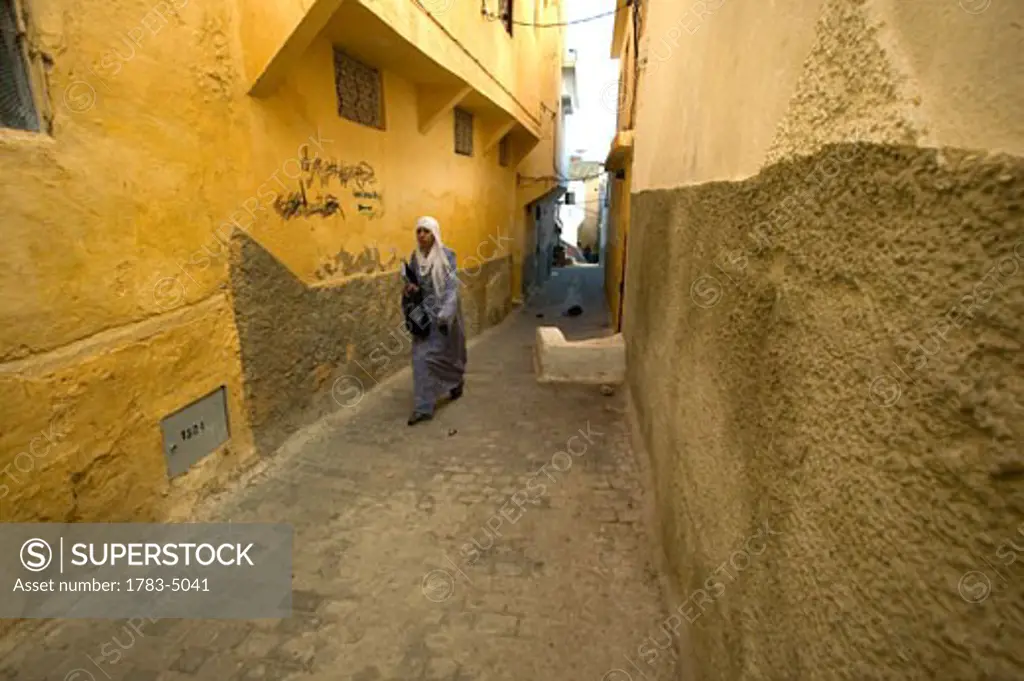 Woman in narrow street in Moulay Idriss, Morocco