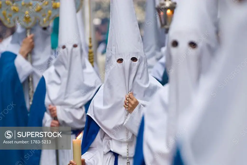 People wearing robes and masks with hoods at Santa Semana Easter festival, Cadiz,Andalucia,Spain