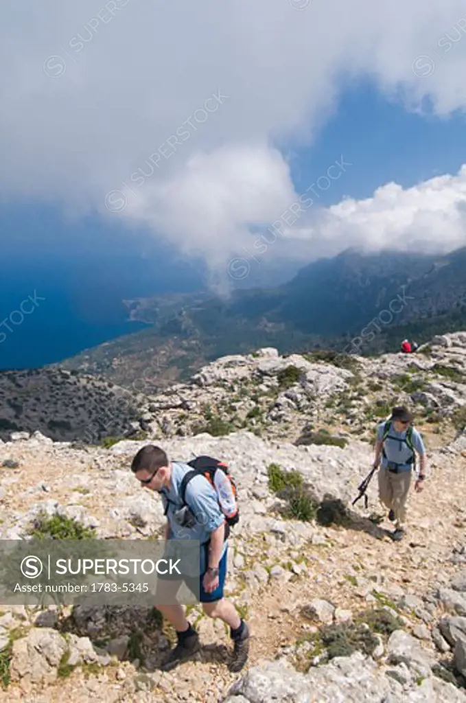 Two men hiking along mountain trail,elevated view, Majorca,Balearic Islands,Spain,track built by Archduke Ludwig Salvador