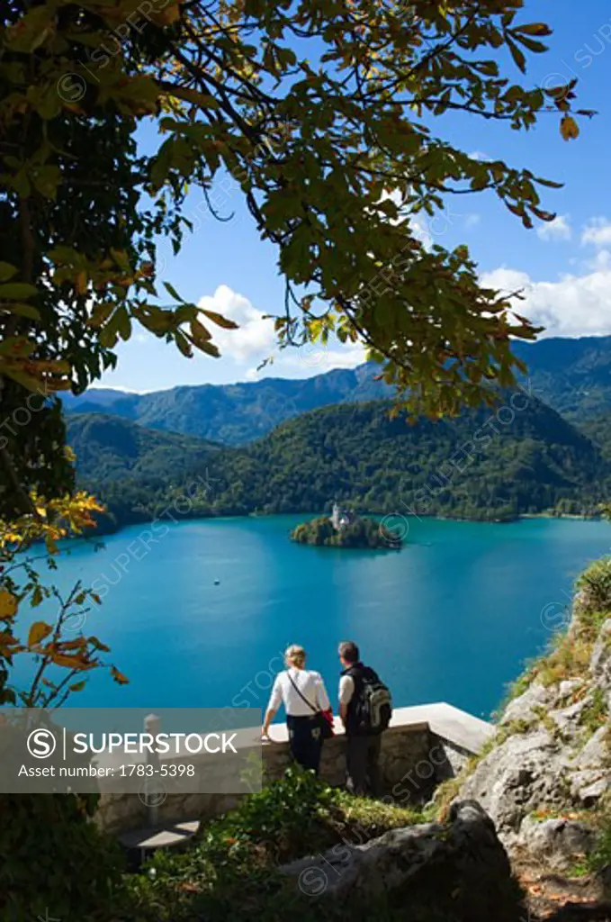 Two tourists looking at Lake Bled from castle, Slovenia