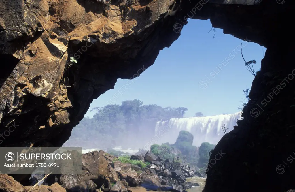 Iguassu falls seen through natural arch, Argentina / Brazil border