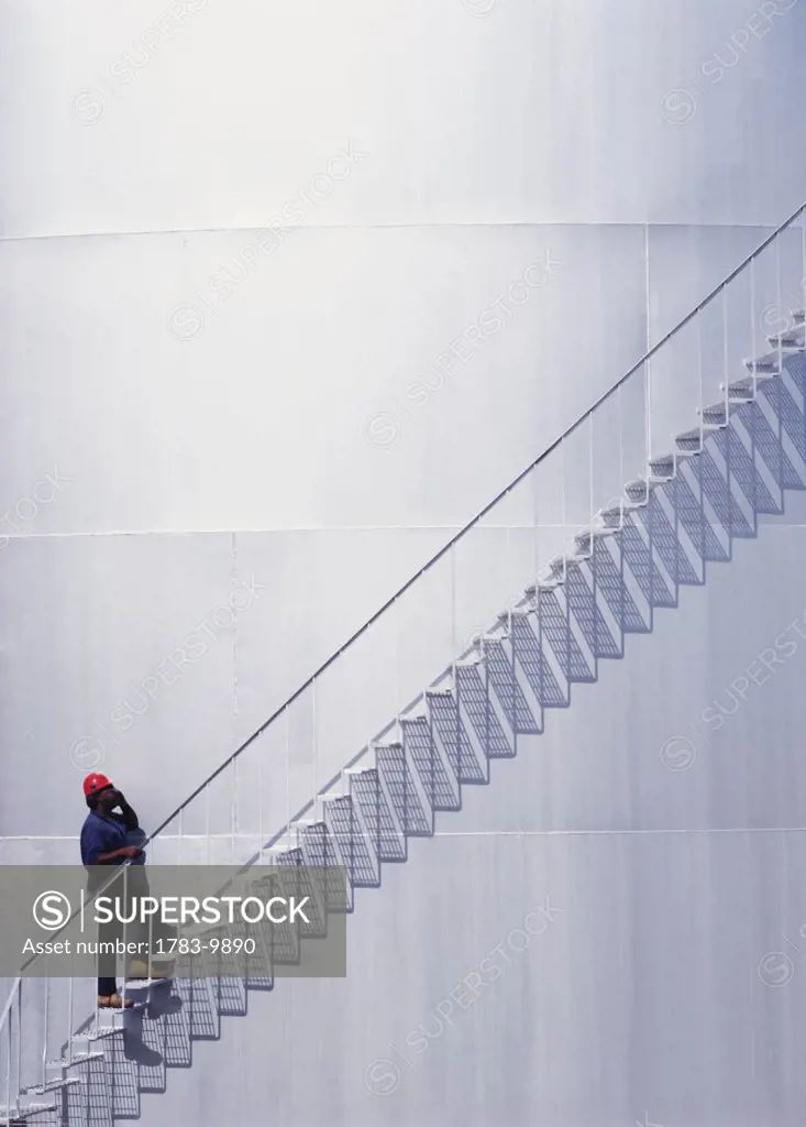 Repairman climbing stairs, Barbados
