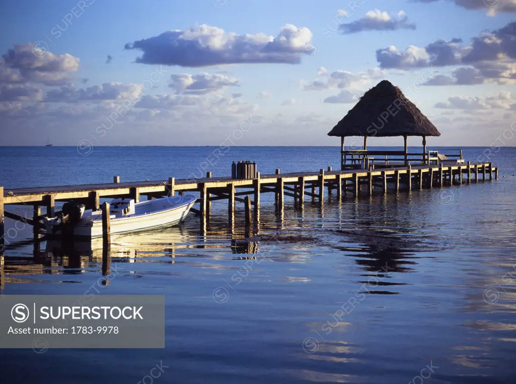 View of the pier across the water at Victoria House., Ambergris Caye, Belize.