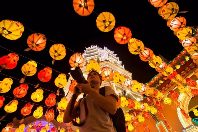 The fantastic lighting of Kek Lok Si Temple and a tourist with a camera; Penang, Malaysia