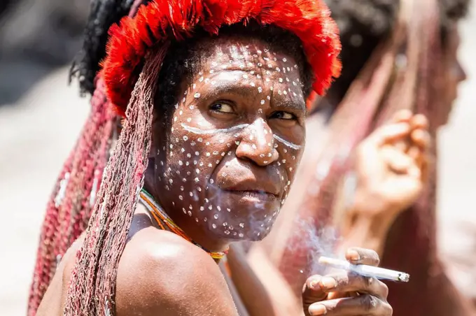 Dani woman smoking a cigarette, Obia Village, Baliem Valley, Central Highlands of Western New Guinea, Papua, Indonesia