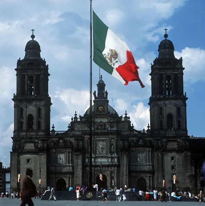 Mexican flag in front of Metropolitan Cathedral, Mexico City, Mexico.