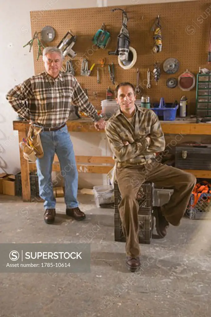 Men wearing plaid shirts in tool workshop