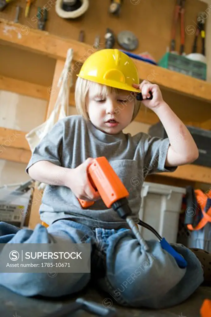Little boy playing with toy tools
