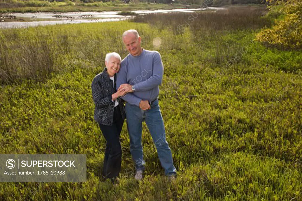 Senior couple standing together enjoying nature