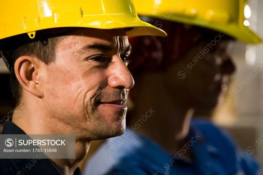 Headshot of two workers wearing hard hats