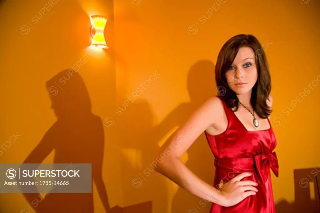 Portrait of beautiful young woman in red cocktail dress