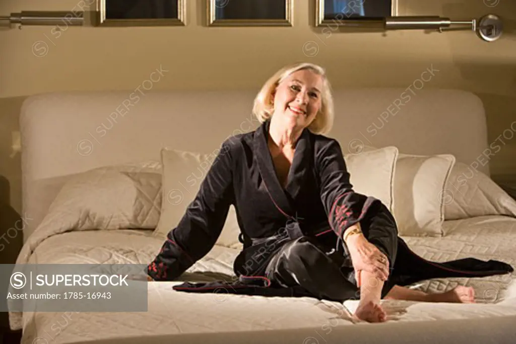Portrait of senior woman relaxing on bed at home