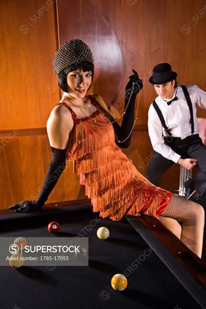 Portrait of 1920s socialite couple at billiards table 1920s bar