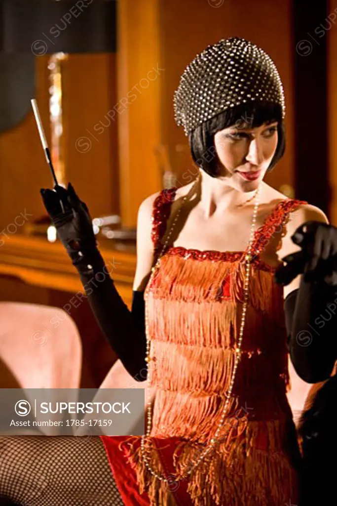 Woman in flapper dress sitting at bar with cigarette in the 1920s