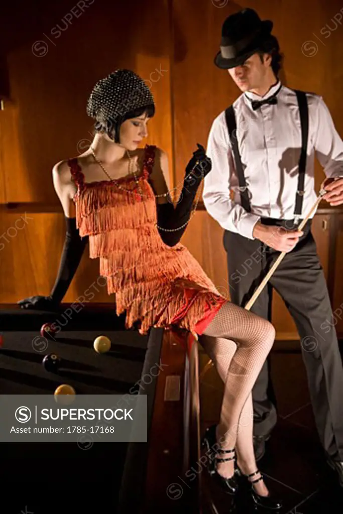 Portrait of 1920s socialite couple at billiards table 1920s bar