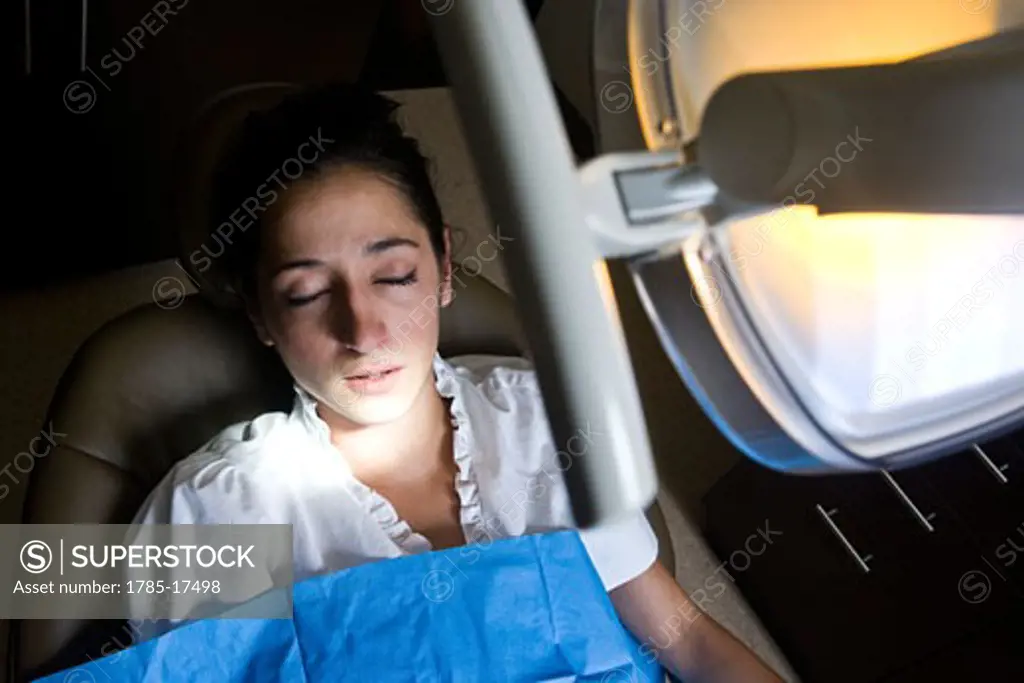 Dental patient in reclining chair with eyes closed